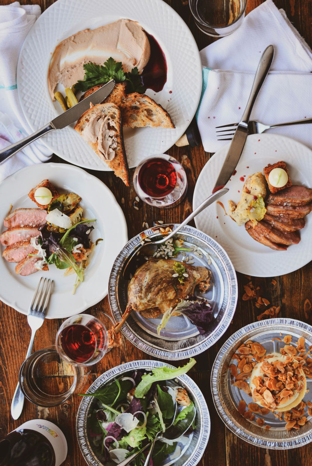 Friends sharing plates of food around a table